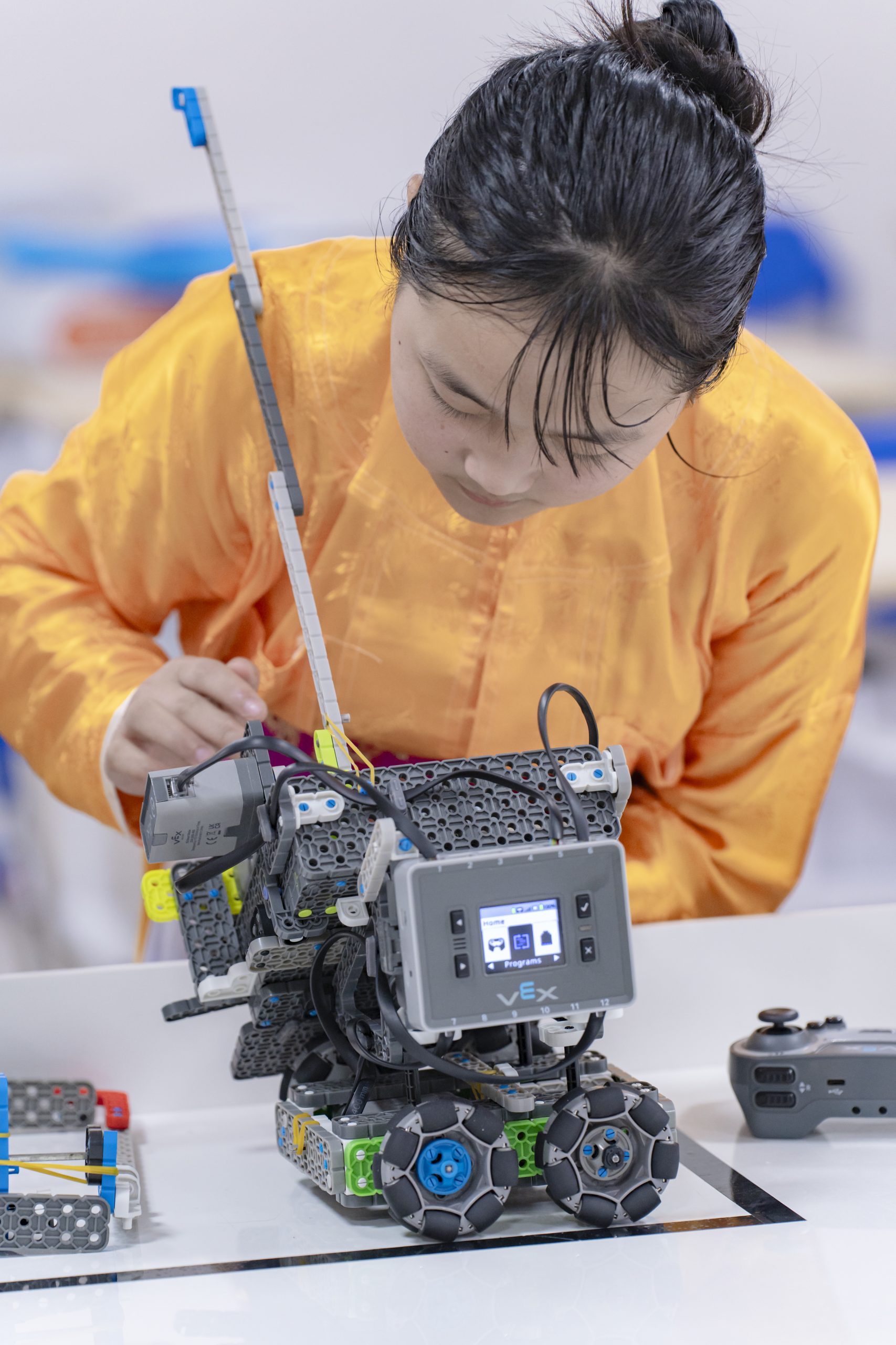 Học sinh nữ trực tiếp thao tác và thử nghiệm robot